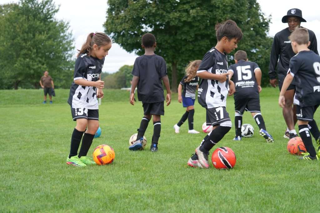 young boys and girls playing soccer